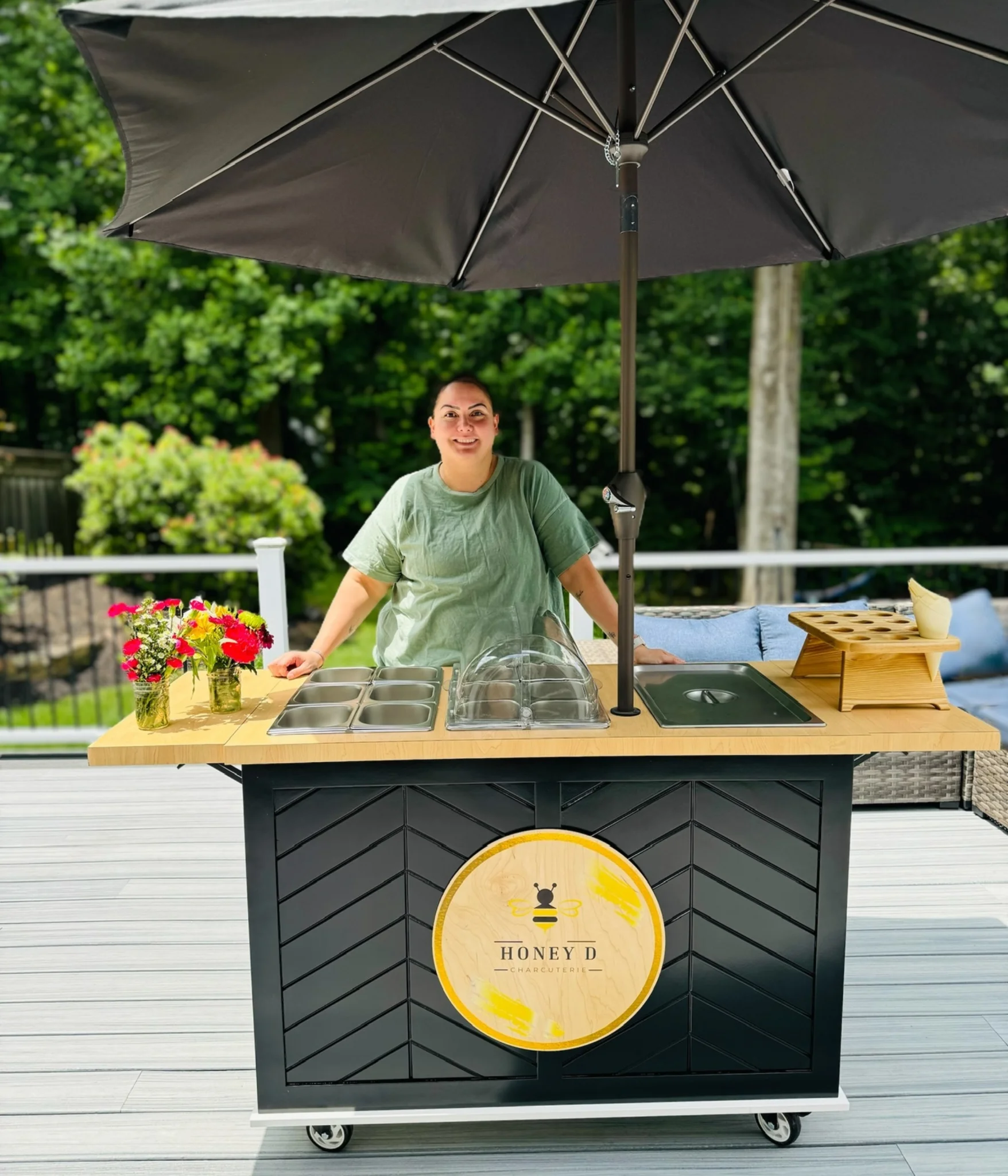 Backyard charcuterie cart service with umbrella and full grazing spread for guests